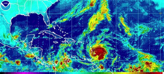 This image provided by NOAA shows Tropical Storm Tomas, lower center, taken early Saturday morning Oct. 30, 2010 at 2:45 a.m. EDT. Tomas had strengthened quickly Friday night with maximum sustained winds of 65 mph (100 kph). Its center was about 100 miles (165 kilometers) southeast of Barbados. Further strengthening was expected, with Tomas possibly becoming a hurricane by Saturday morning. (AP Photo/NOAA)